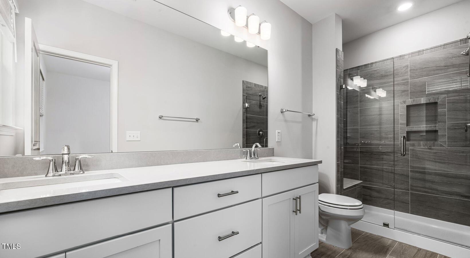 3709 Nova Star Lane, Unit GARRISON Raleigh, NC 27612 - Photo 21 of 30 a bathroom with a sink a toilet and shower