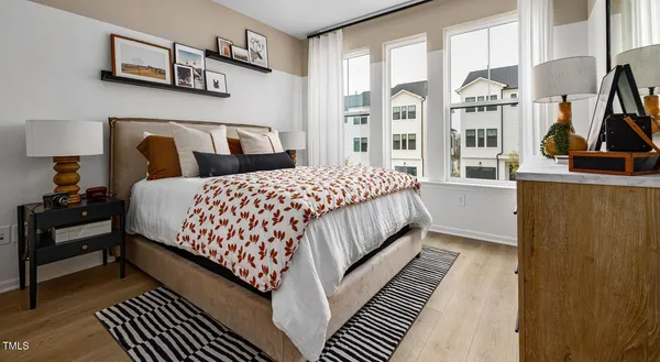 a bedroom with bed and a large window