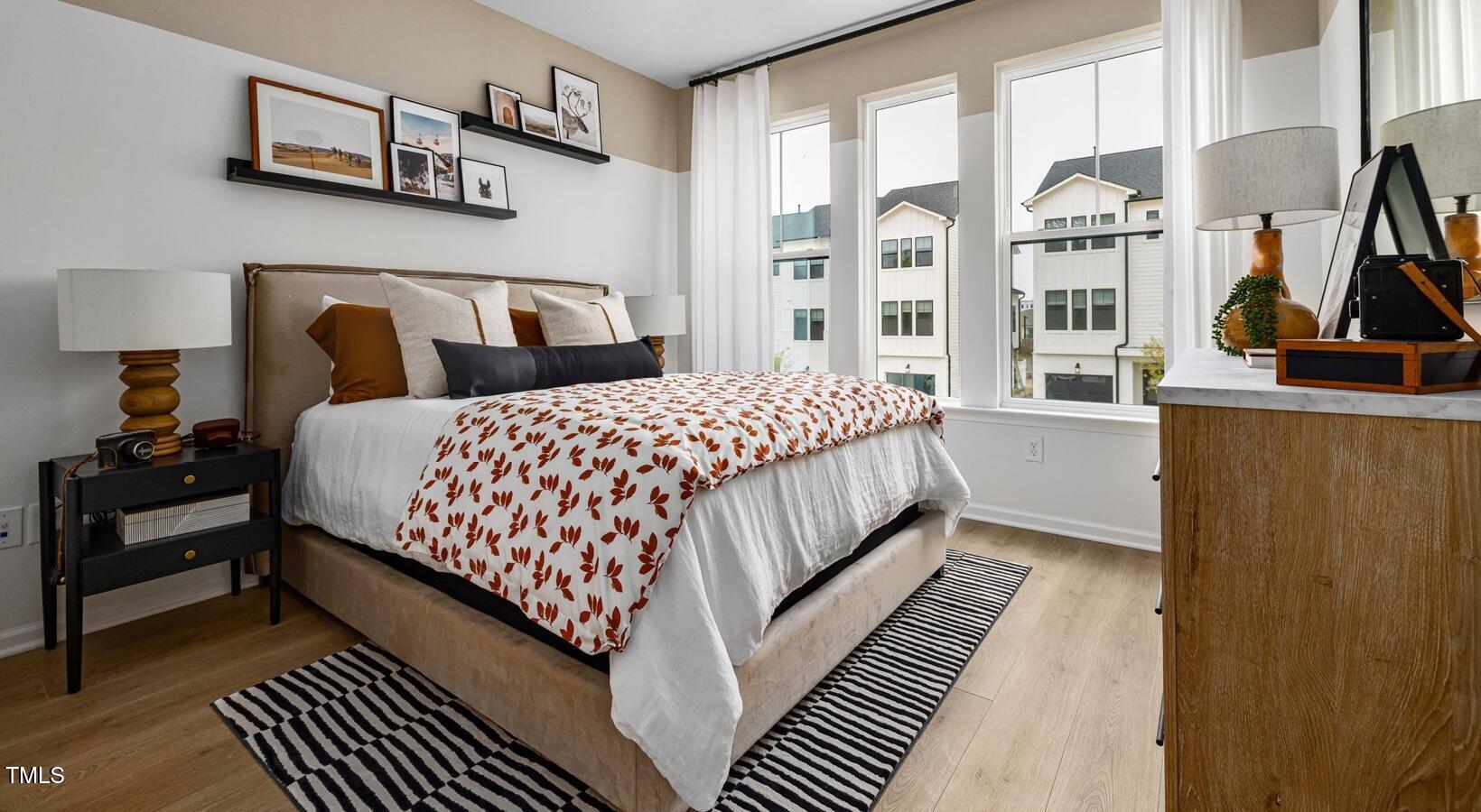 3709 Nova Star Lane, Unit GARRISON Raleigh, NC 27612 - Photo 24 of 30 a bedroom with bed and a large window