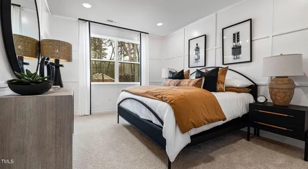 a spacious bedroom with a bed and wooden floor