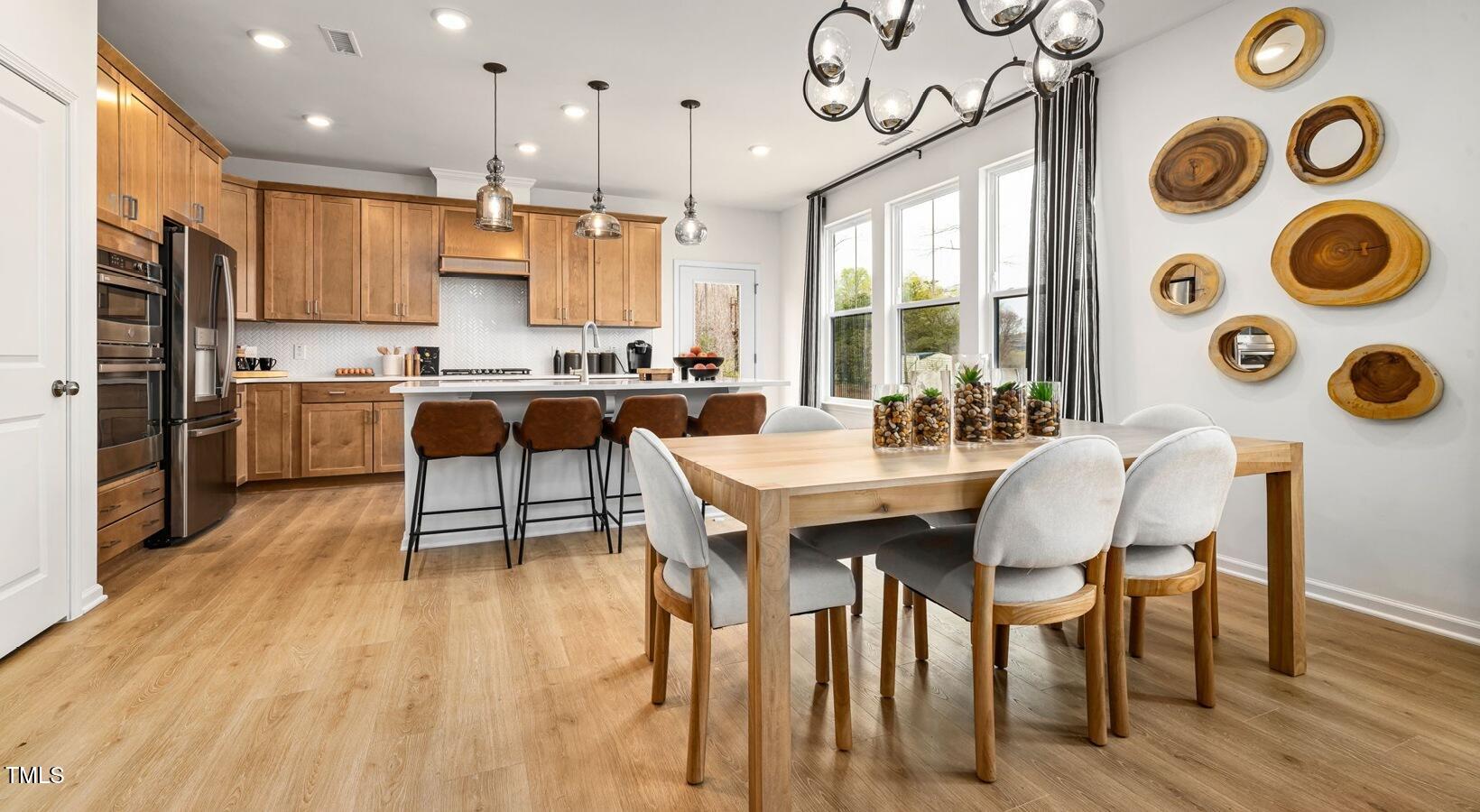 3709 Nova Star Lane, Unit GARRISON Raleigh, NC 27612 - Photo 3 of 30 a large kitchen with a table and chairs