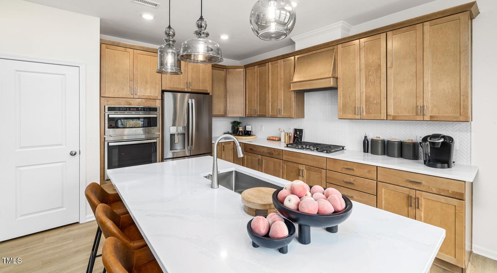 3709 Nova Star Lane, Unit GARRISON Raleigh, NC 27612 - Photo 6 of 30 a kitchen with a refrigerator and a sink
