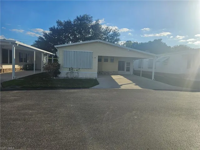 a view of a house with a yard and garage