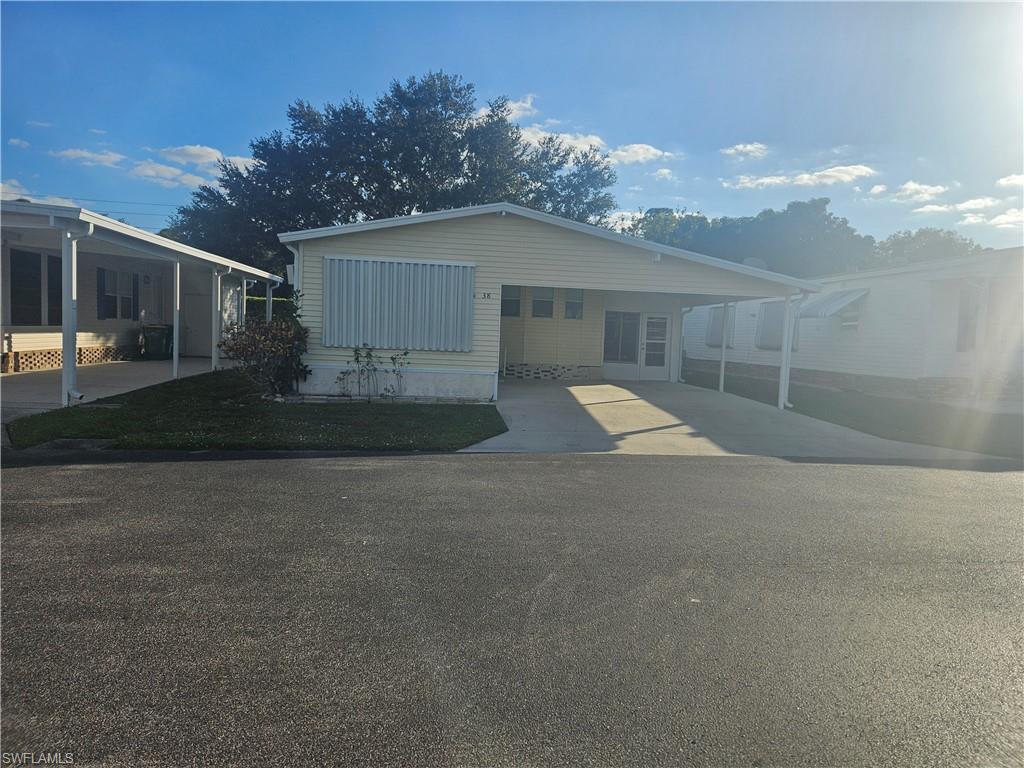 a view of a house with a yard and garage