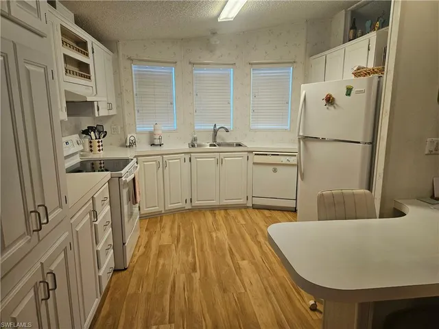 a spacious bathroom with a tub sink and mirror