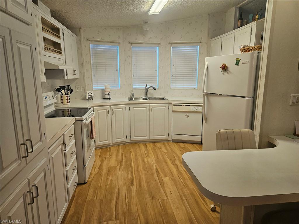 38 Turquoise Avenue, Unit 38T Naples, FL 34114 - Photo 13 of 29 a spacious bathroom with a tub sink and mirror