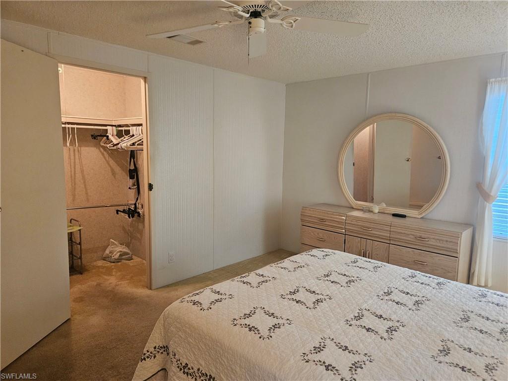 38 Turquoise Avenue, Unit 38T Naples, FL 34114 - Photo 17 of 29 a bedroom with a bed and a dresser