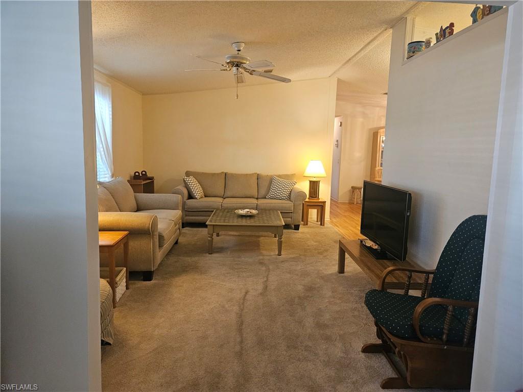 38 Turquoise Avenue, Unit 38T Naples, FL 34114 - Photo 22 of 29 a living room with furniture and a flat screen tv
