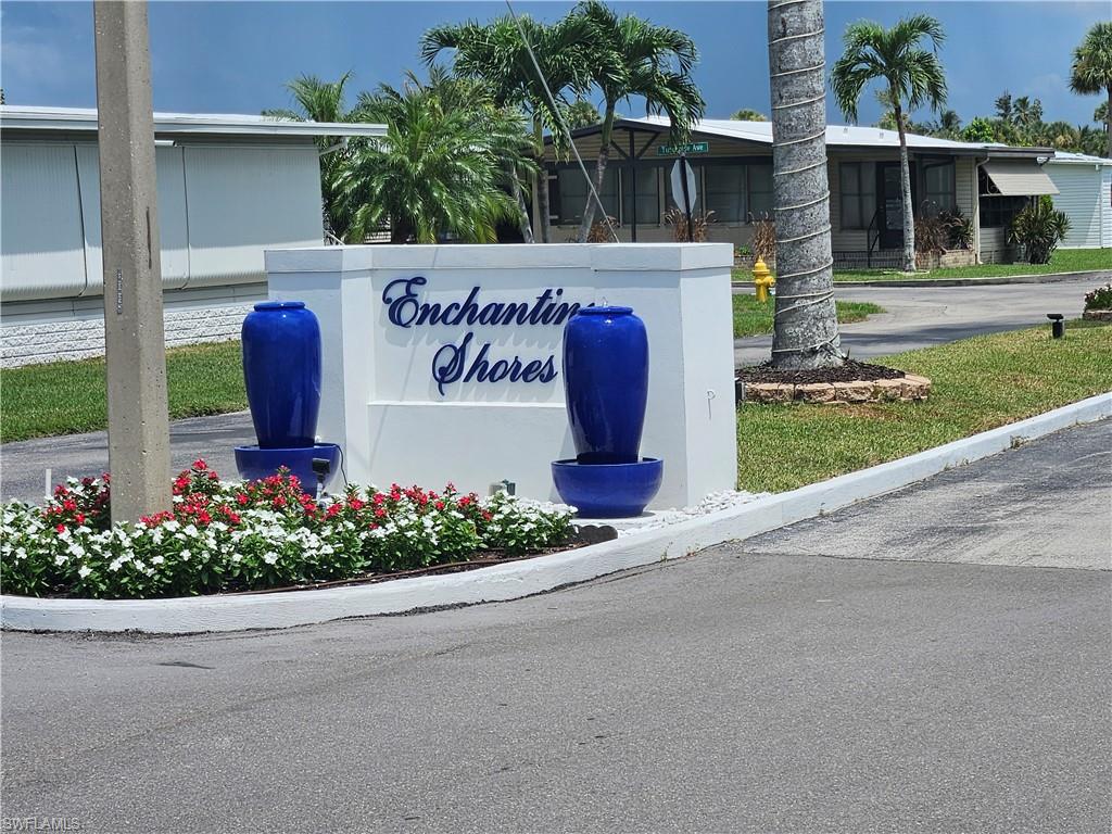 38 Turquoise Avenue, Unit 38T Naples, FL 34114 - Photo 23 of 29 a sign that is in front of flowers