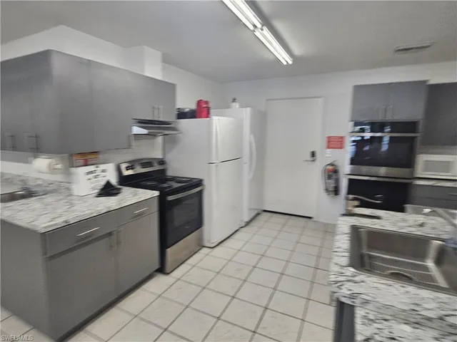 a kitchen with a stove top oven and cabinets