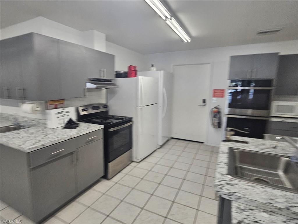 38 Turquoise Avenue, Unit 38T Naples, FL 34114 - Photo 26 of 29 a kitchen with a stove top oven and cabinets