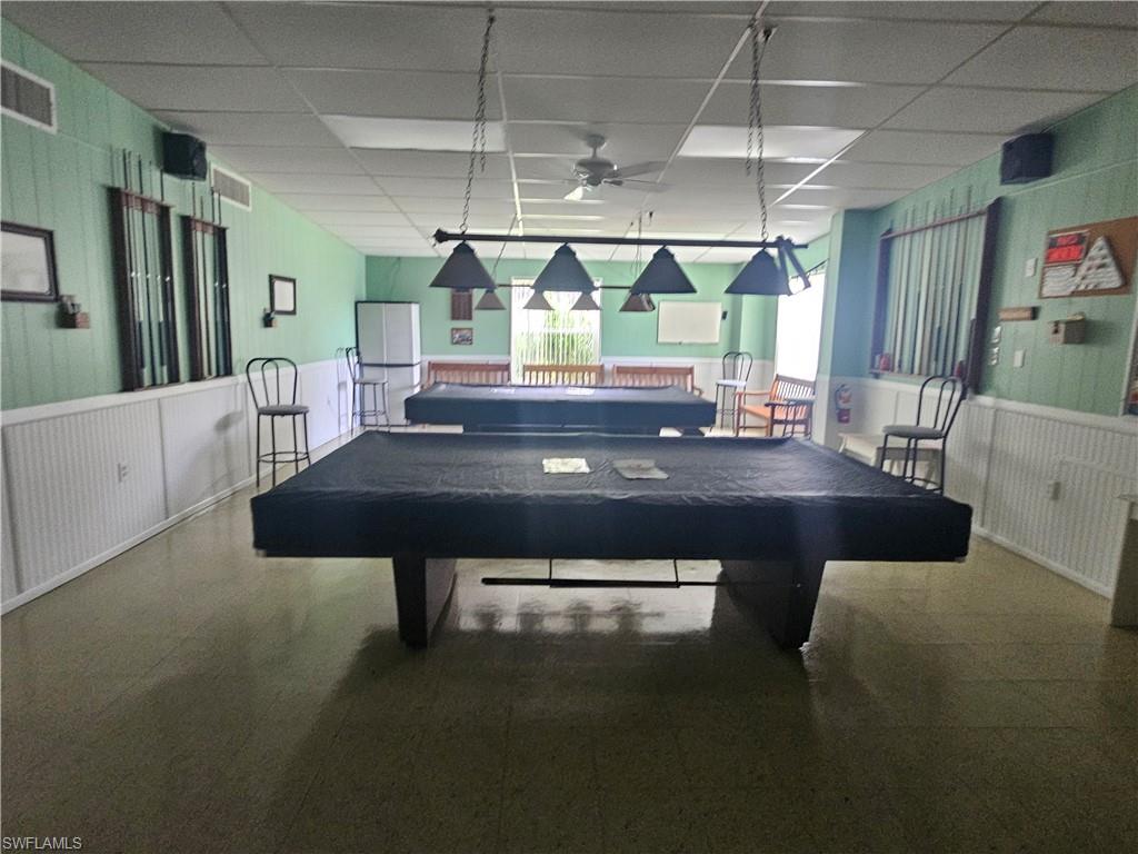 38 Turquoise Avenue, Unit 38T Naples, FL 34114 - Photo 29 of 29 a room with furniture and a large window