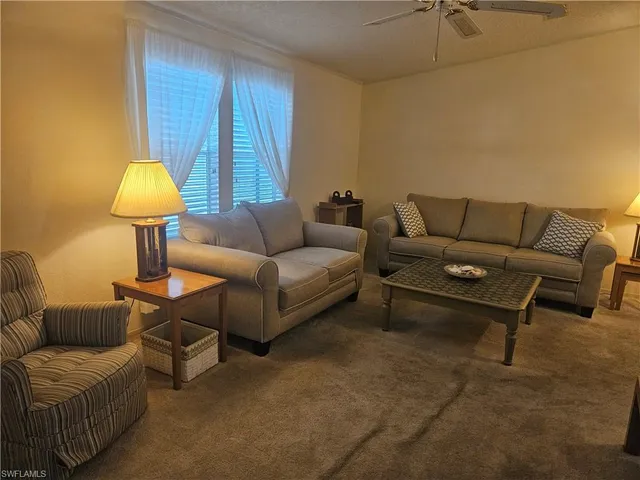 a living room with furniture and a lamp