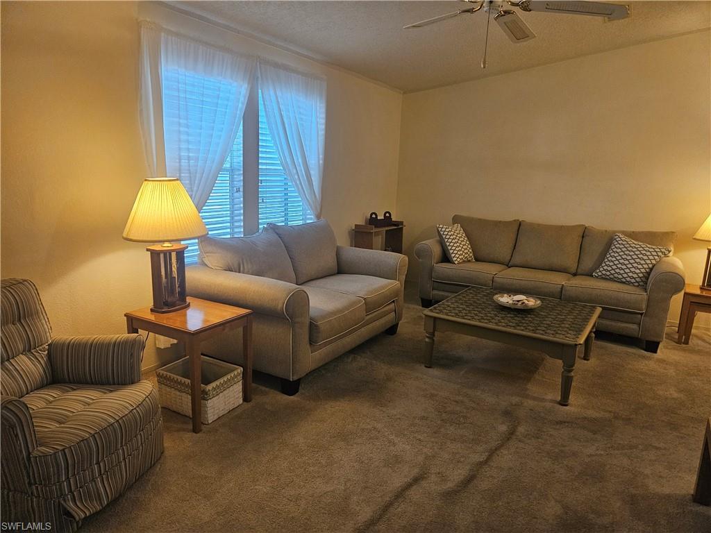 38 Turquoise Avenue, Unit 38T Naples, FL 34114 - Photo 8 of 29 a living room with furniture and a lamp