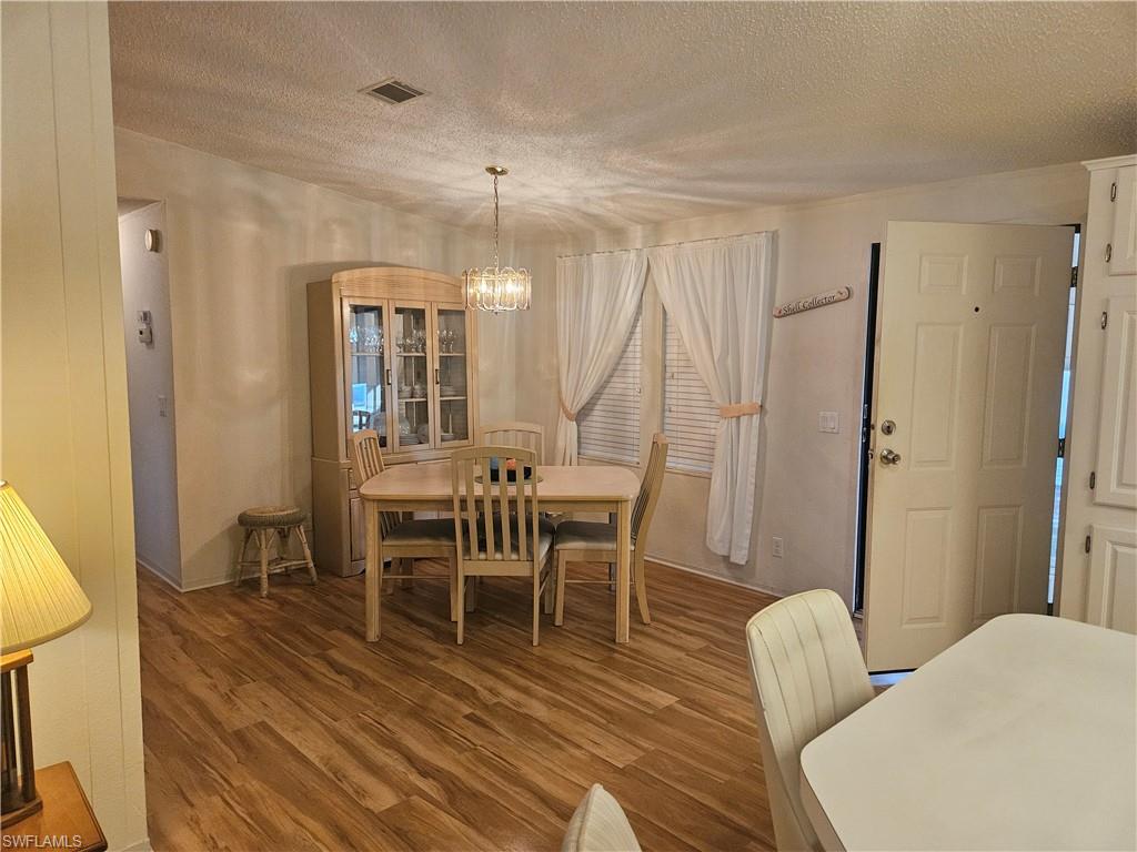 38 Turquoise Avenue, Unit 38T Naples, FL 34114 - Photo 10 of 29 a view of a dining room with furniture and wooden floor