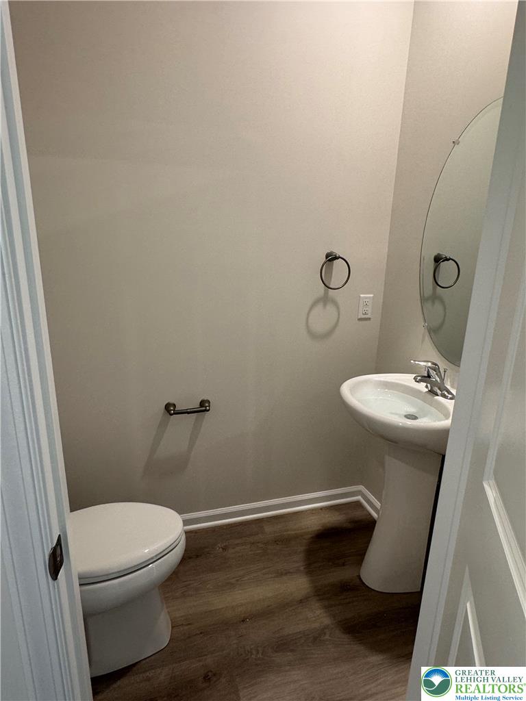 1168 Martin Road Breinigsville, PA 18031 - Photo 5 of 11 A compact and functional powder room with rich wood-look flooring.