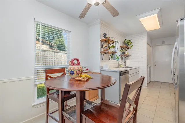 a view of a dining room with furniture and window