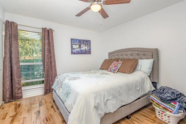 a bedroom with a bed and a large window