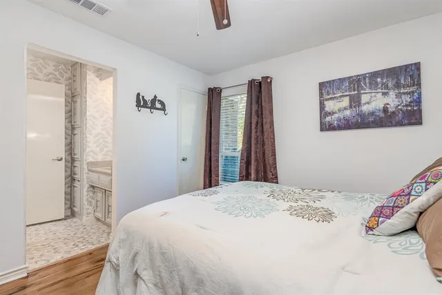 a bedroom with a bed and a painting on the wall