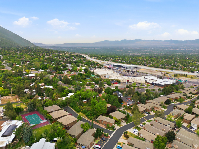 3674 Oak Rim Way Salt Lake City, UT 84109 - Photo 44 of 47 Aerial perspective showcasing a residential area with diverse properties, a prominent retail complex, a multi-lane highway, and distant mountain ranges
