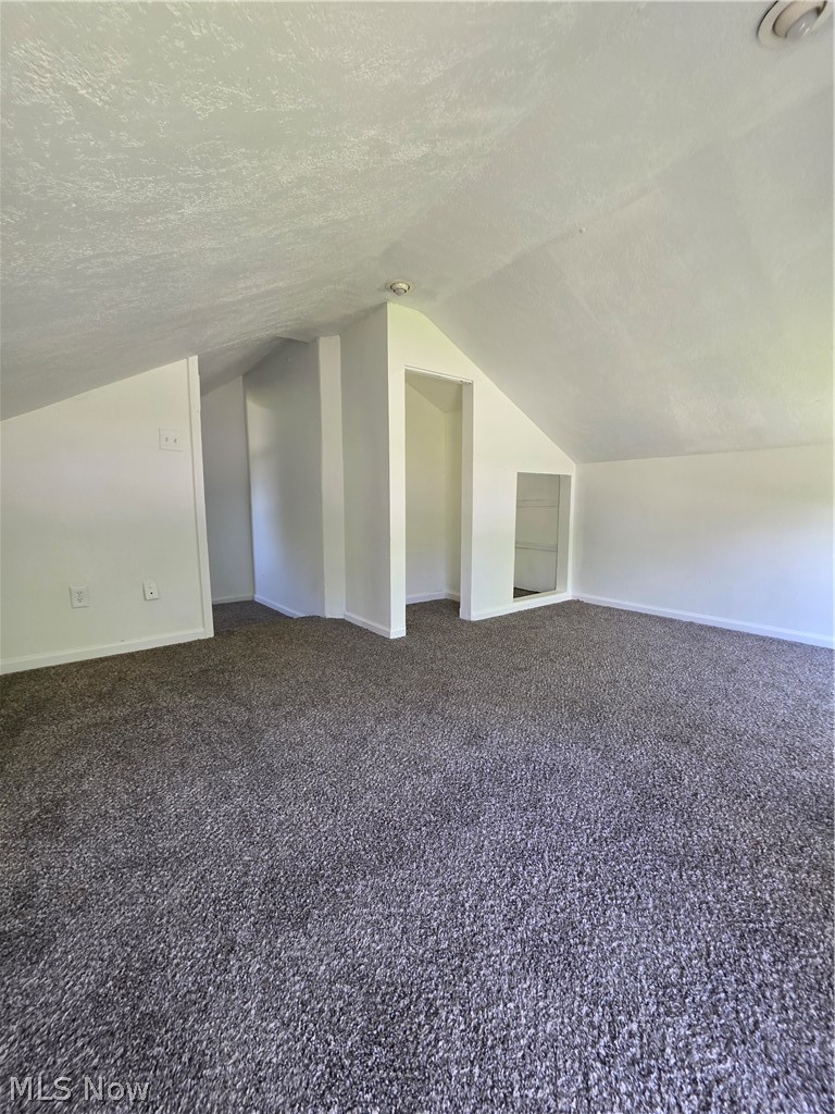 5860 Kirk Road Canfield, OH 44406 - Photo 12 of 12 Carpeted attic space featuring sloped ceilings, recessed lighting, and built-in alcoves