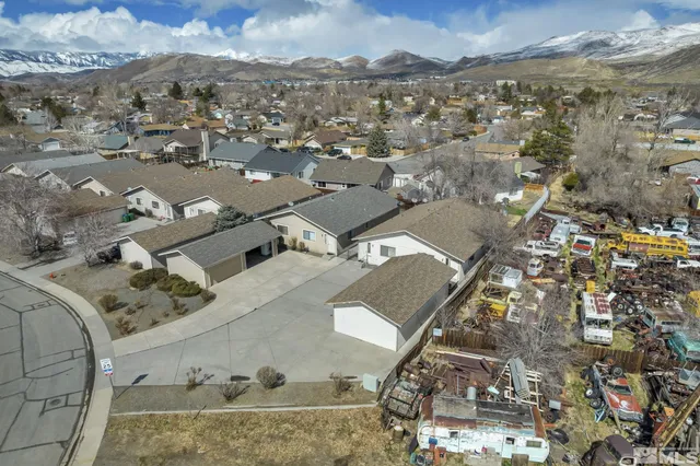 an aerial view of a house with a mountain