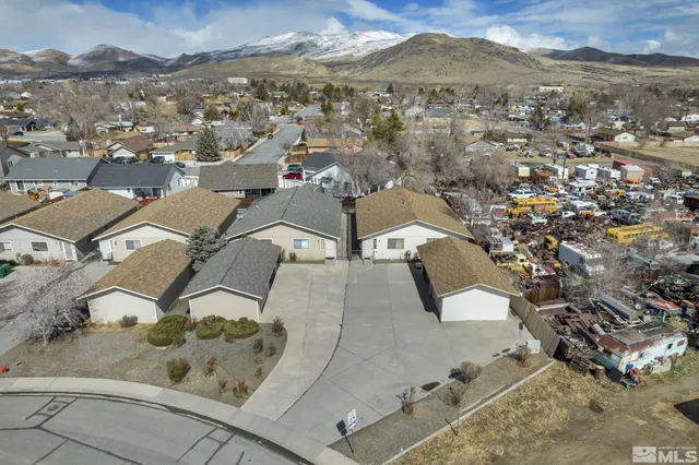 an aerial view of a house with a mountain