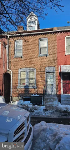 a front view of a house with sitting area