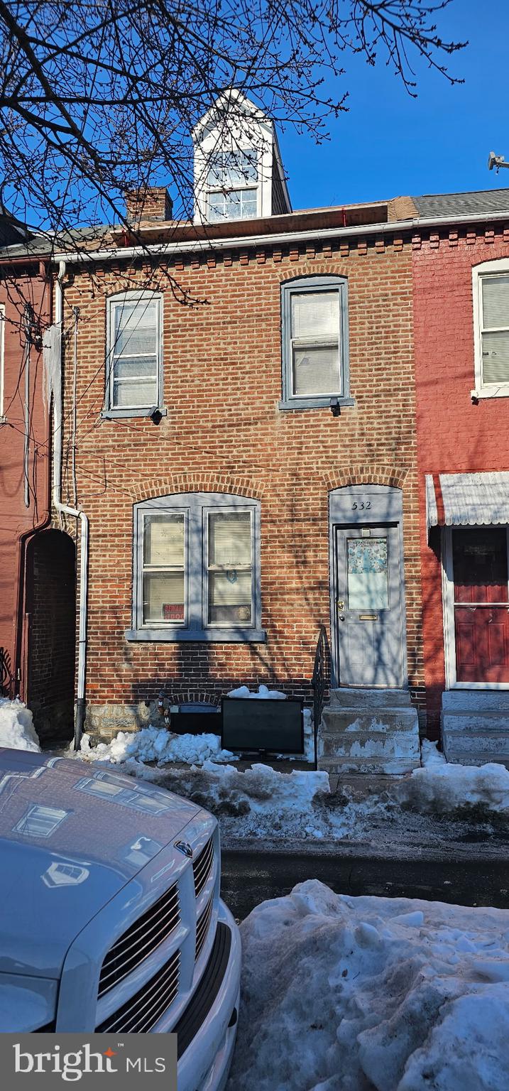 a front view of a house with sitting area
