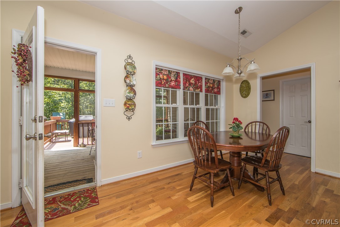 4625 Treely Road Chester, VA 23831 - Photo 23 of 50 a dining room with furniture a chandelier and wooden floor