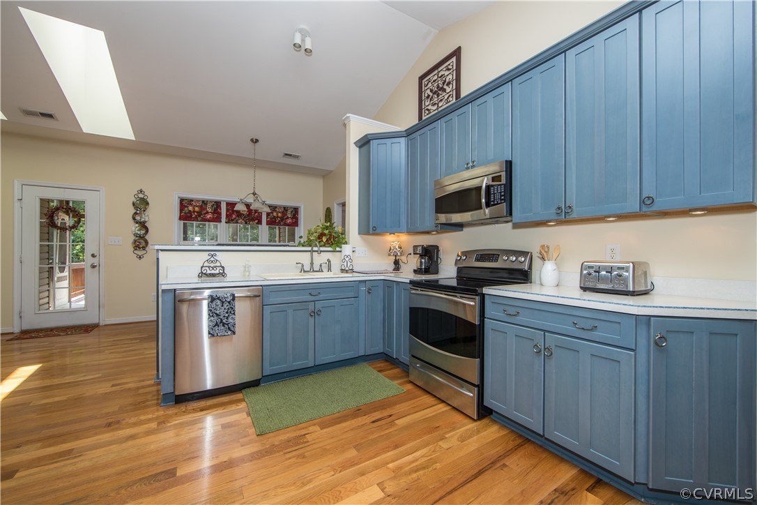 4625 Treely Road Chester, VA 23831 - Photo 27 of 50 a kitchen with stainless steel appliances granite countertop a stove top oven a sink dishwasher and a refrigerator with wooden cabinets