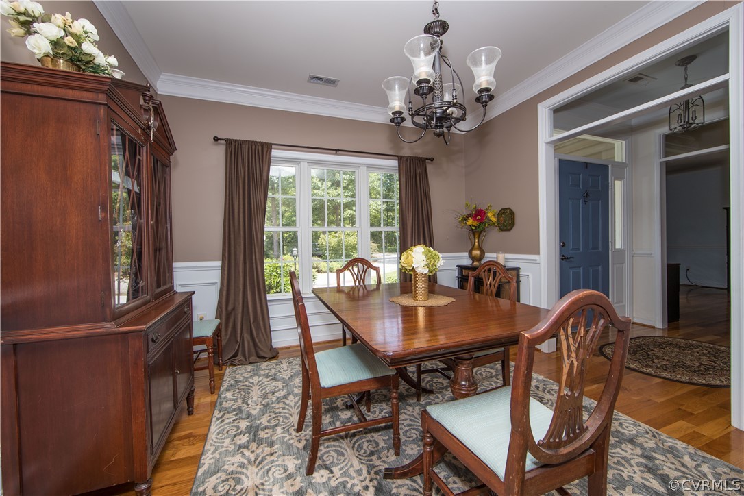 4625 Treely Road Chester, VA 23831 - Photo 29 of 50 a view of a dining room with furniture a chandelier and wooden floor
