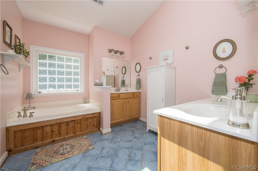 4625 Treely Road Chester, VA 23831 - Photo 35 of 50 a spacious bathroom with a double vanity sink a mirror and a bathtub