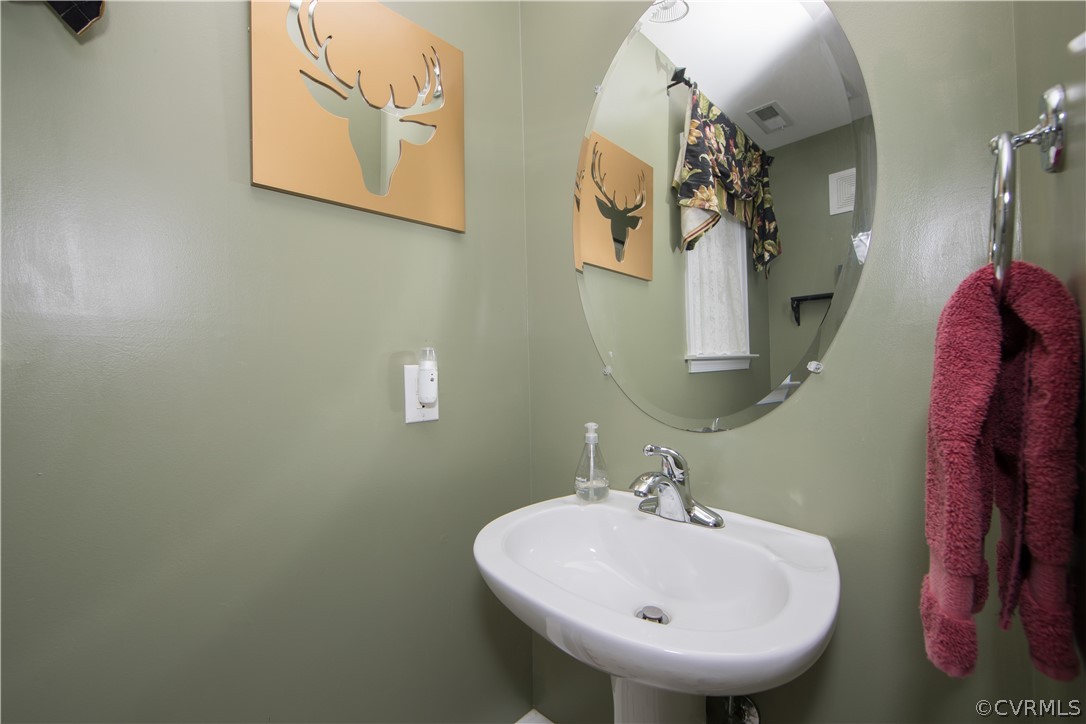 4625 Treely Road Chester, VA 23831 - Photo 10 of 50 a bathroom with a sink and mirror