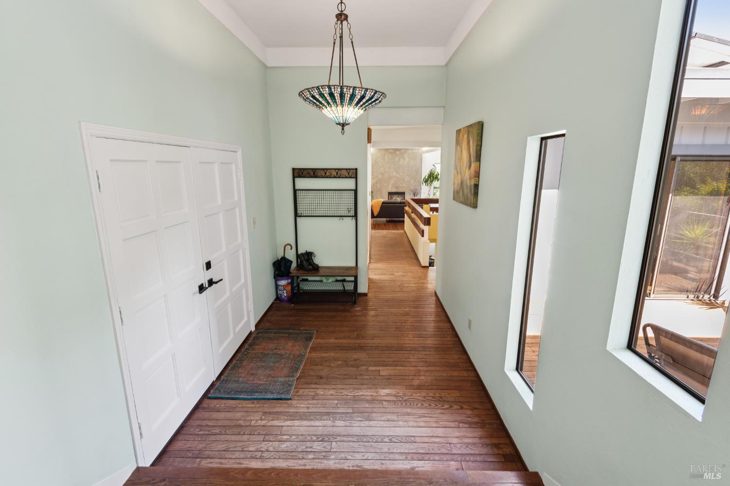 1475 Los Olivos Road Santa Rosa, CA 95404 - Photo 9 of 51 a view of a hallway with wooden floor and staircase