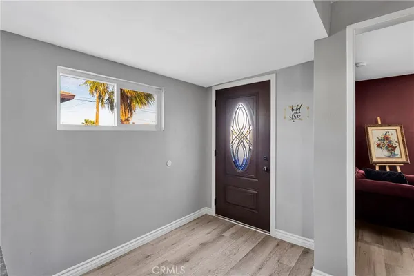 a living room with furniture a flat screen tv and a window