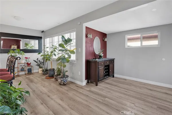 a kitchen with stainless steel appliances kitchen island granite countertop a dining table chairs refrigerator and sink