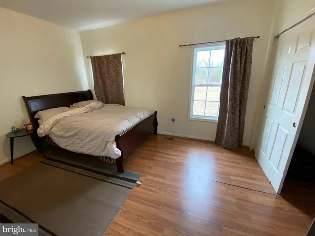 a bedroom with bed and window