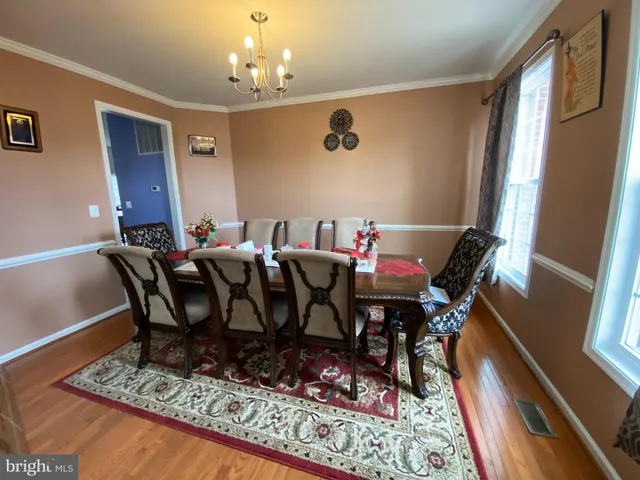 a view of a dining room with furniture wooden floor and a rug