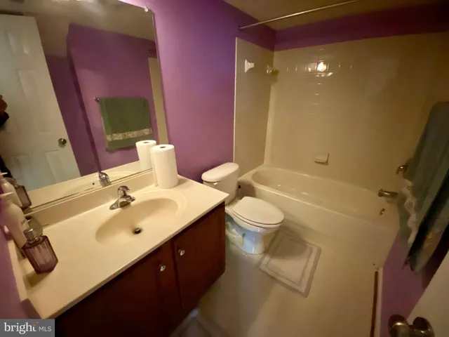 a bathroom with a sink mirror vanity toilet and shower