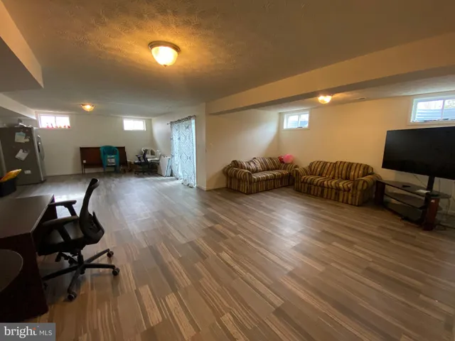 a view of a livingroom with furniture and a flat screen tv