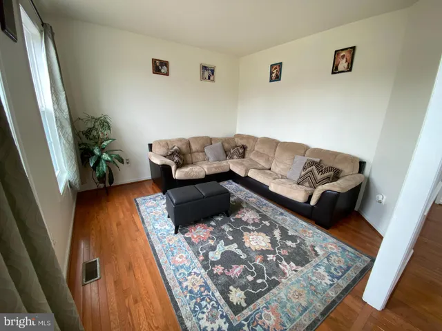a living room with furniture and a rug