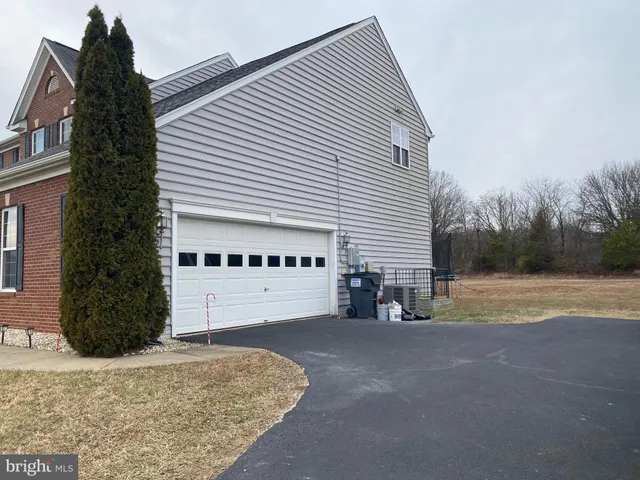 a view of a house with a yard and garage