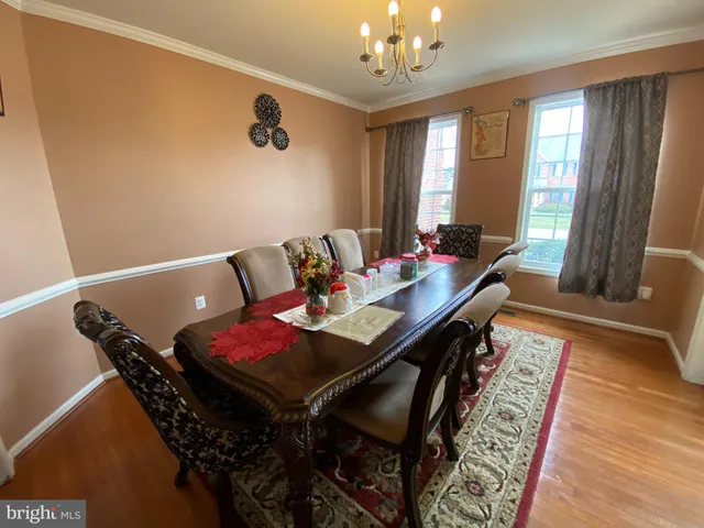 a view of a dining room with furniture and a chandelier