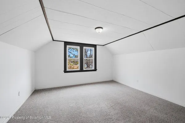 a view of an empty room with windows