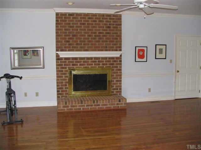 4324 Swarthmore Road Durham, NC 27707 - Photo 7 of 7 family room has hardwood flooring, a wood burning fireplace and custom built ins