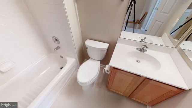 a bathroom with a sink a toilet and bathtub