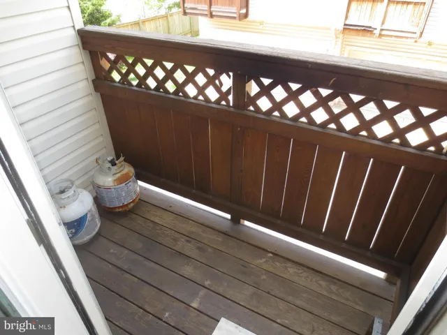 a view of a balcony with wooden floor