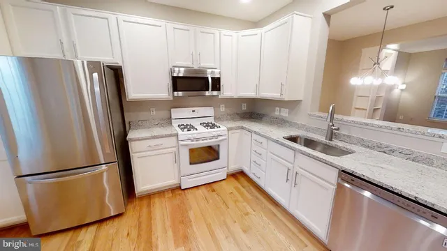 a kitchen with a refrigerator sink and microwave