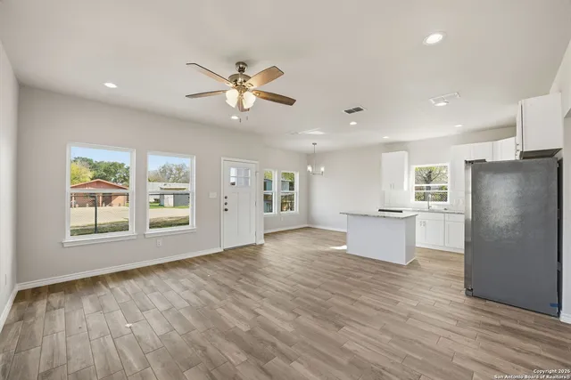 a view of a kitchen with a sink and a refrigerator